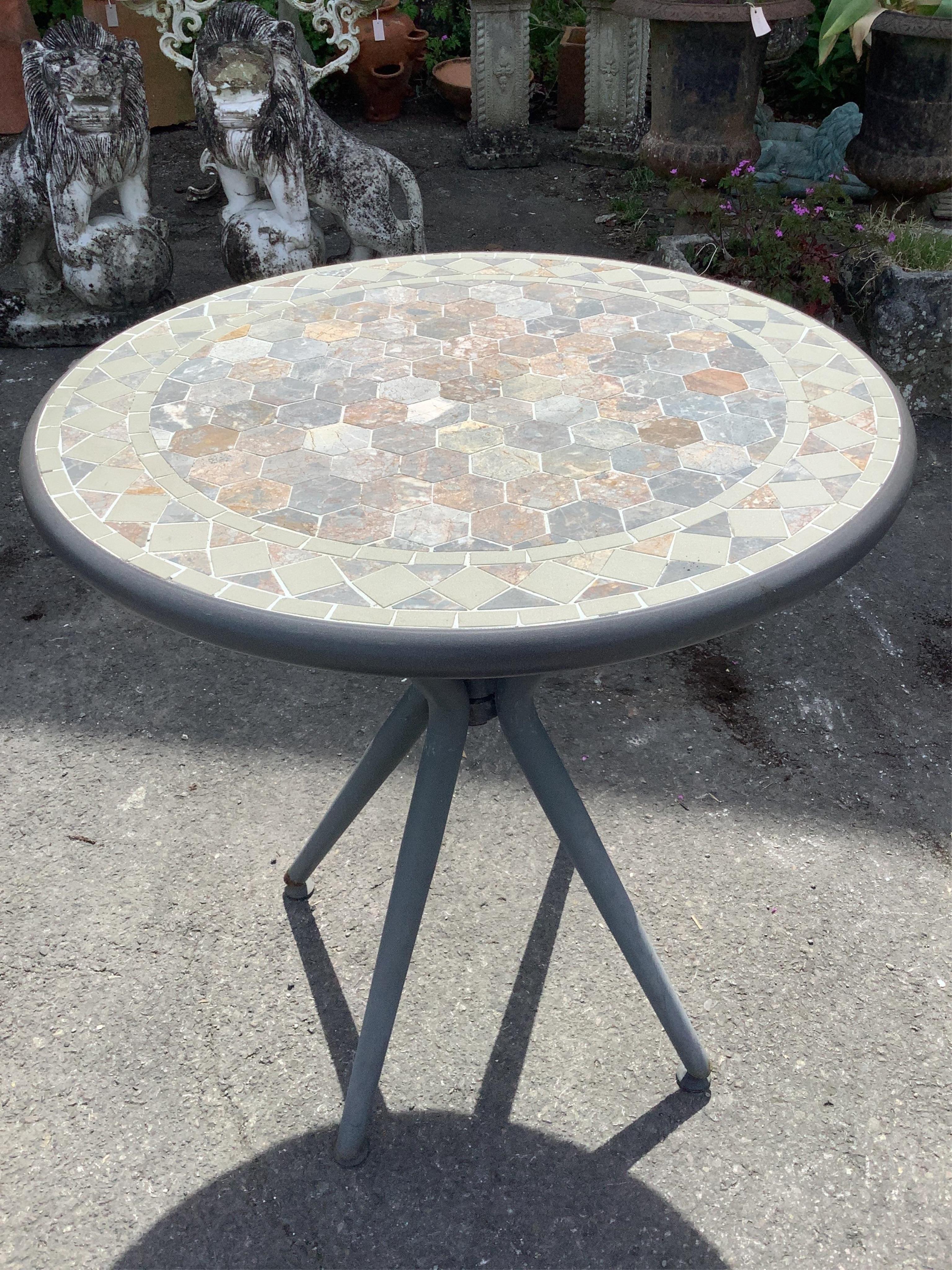 A circular mosaic stone garden table, diameter 69cm, height 75cm and two metal chairs